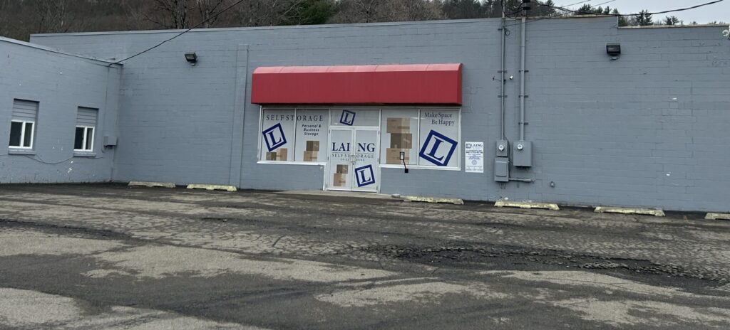 Laing Self Storage of Greene NY exterior with red awning and secure climate-controlled storage facility entrance